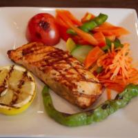 Salmon · Grilled filet of salmon, drizzled over lemon olive oil sauce.