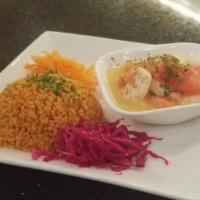 Shrimp Tava · Sautéed shrimp with lemon olive oil sauce and garlic topped with chopped tomatoes.