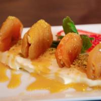 Apricot Delight · Sun dried apricots stuffed with walnuts, baked in honey syrup, served with vanilla mascarpon...