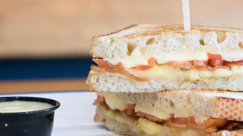 Grilled Cheese · Country White Sliced Bread, Aged Cheddar, Havarti, Cured Bacon, Sliced Tomato, Mornay Sauce
