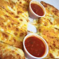 Cheesy Bread · Ten inches pizza crust glazed with garlic sauce and topped with Mozzarella cheese. Served wi...