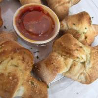 Garlic Knots · Homemade dough cut into small balls, baked to perfection, brushed with garlic sauce, seasone...