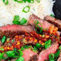 Steak Rice Bowl · Tender, juicy marinated ribeye with a side of rice, house-made garlic chili lime dipping sau...