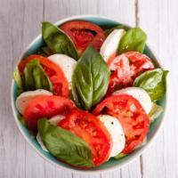 Caprese Salad · Thick slices of ripe beefsteak tomatoes, artisan mozzarella cheese, fresh sweet basil, and a...