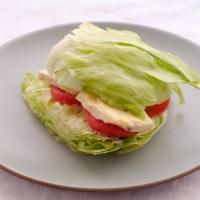 Wedge Salad · An old school classic. Crisp wedge of lettuce with loads of chunky blue cheese, bacon bits a...