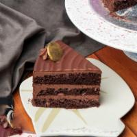 Chocolate Cake · Deep, dark, rich two layer cake, drenched in chocolate syrup and covered with soft, chocolat...