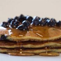 Blueberry Pancakes · Stack of three golden brown pancakes with blueberries.