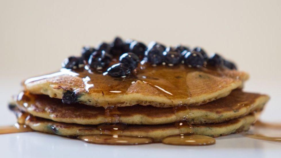 Blueberry Pancakes · Stack of three golden brown pancakes with blueberries.