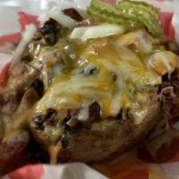 Outlaw Potato  · Chop brisket and sausage stuffed in a huge potato with butter and cheese