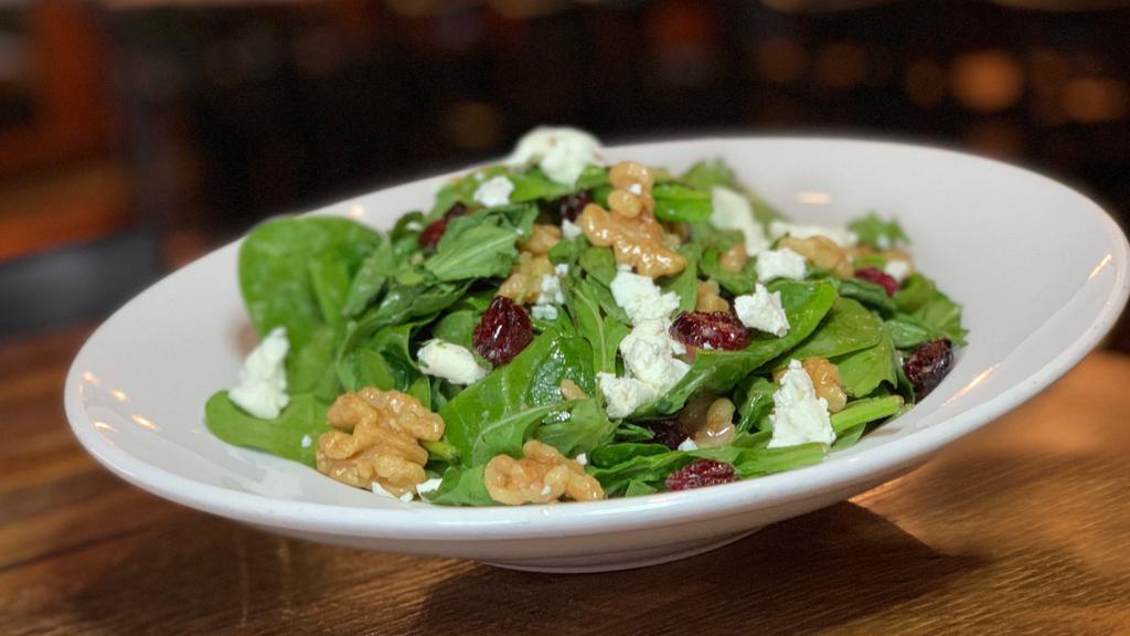 Goat In The Garden · Baby arugula, spinach leaves, dried cranberries, candied walnuts, goat cheese, red wine and vinegar dressing.