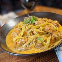 Blackened Chicken Linguine · Cajun spiced chicken seared with mushroom, green onions and tomato, finished with asiago cre...