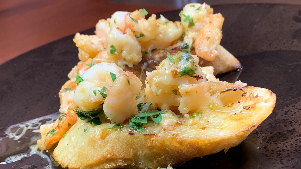 Baked Shrimp Scampi · Confit garlic butter sauce, havarti cheese and toasted baguette.
