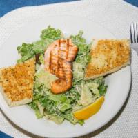 Blacken Salmon Caesar · Crisp romaine hearts tossed with Parmesan cheese, croutons, and our house caesar with blacke...