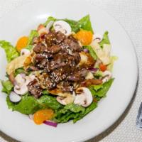 Thai Beef Salad · Tender flank steak marinated then char-broiled with red onion, mushrooms, tomatoes, and wont...