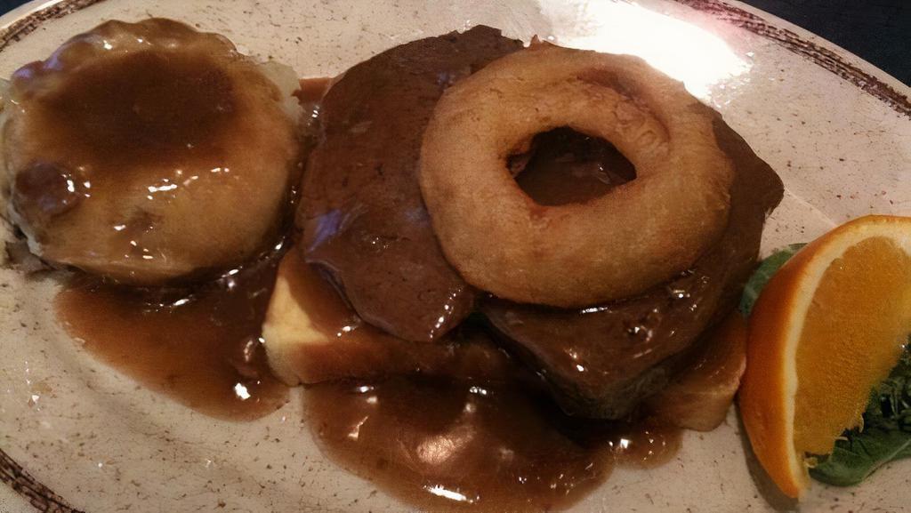 Dinner Meatloaf Plate · Prepared daily, fresh ground chuck seasoned herbs. Served over mashed potatoes with rich brown gravy. Topped off with golden onion rings.