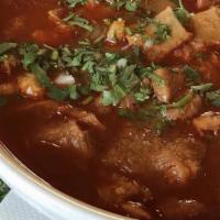 Sopa De Gallina India · A delicious hen consomme with potatoes, carrots, corn, zucchini, onion, tomatoes, and cilant...