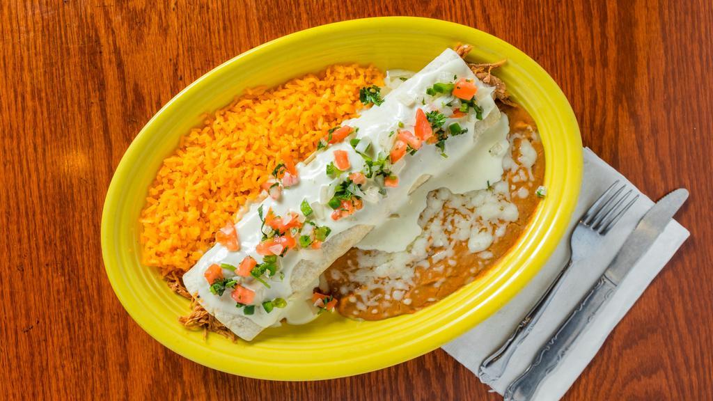 Burrito Tapatio · A very tasty sautéed pork burrito with beans and smothered with melted cheese. Served with Spanish rice and pico de gallo.