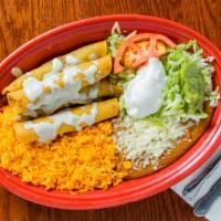 Taquitos Aztecas · Four taquitos, two shredded beef, two chicken, covered with our cheese sauce. Served with le...