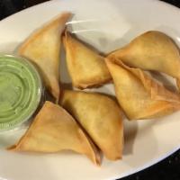 Samosas · Fried pastries filled with potatoes, green peas and spices; served with yogurt chutney. Serv...
