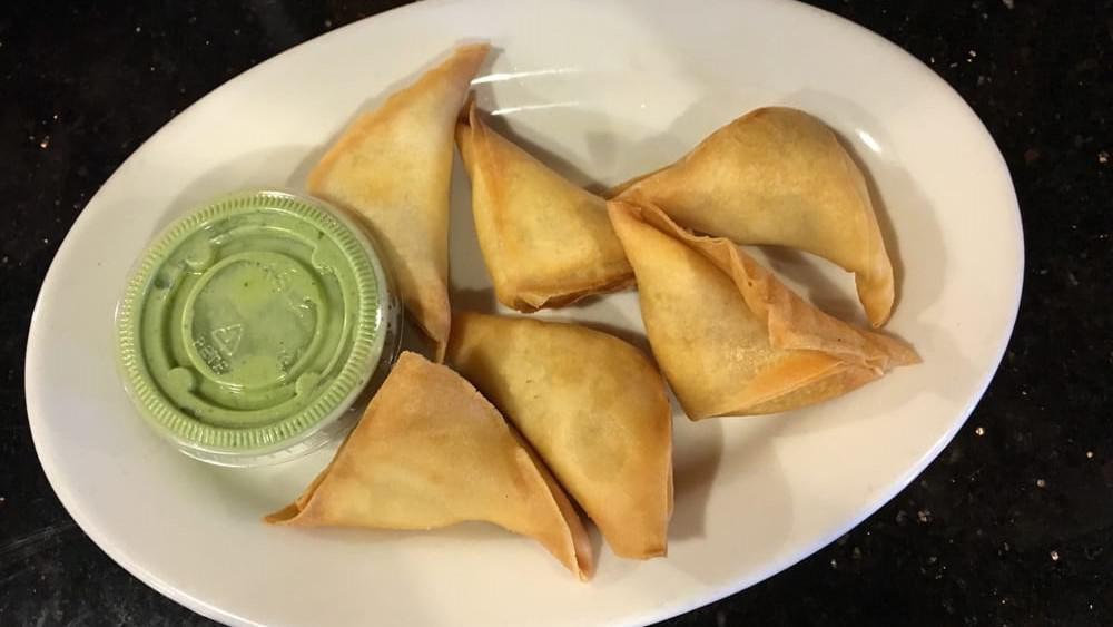Samosas · Fried pastries filled with potatoes, green peas and spices; served with yogurt chutney. Serves four.