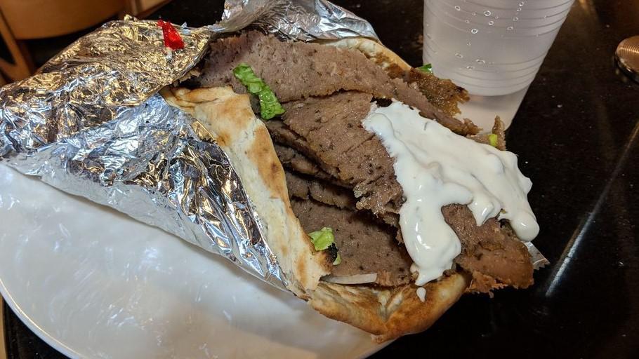 Gyro Wrap · Seasoned lamb and beef roasted on a rotisserie with romaine lettuce,  tomatoes, cucumbers, feta cheese, onions, and tzatziki sauce.