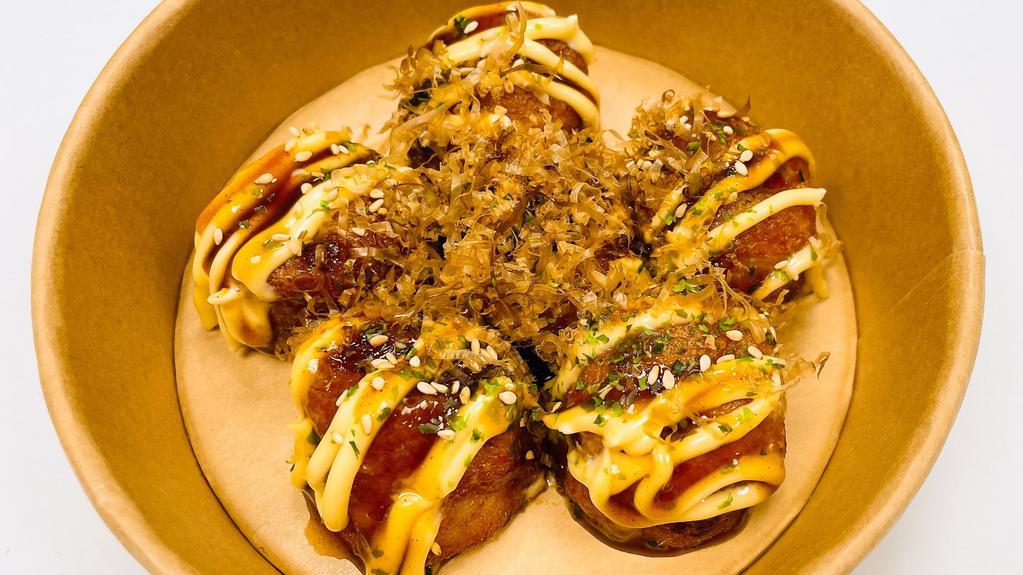 Takoyaki (6 Pieces) · Deep fried balll-shaped flour filled with diced Octopus; topped with Eel sauce, Mayo, Bonito flakes, sesame seeds, and shredded seaweed.