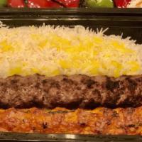 (C8). Combo Koobideh · A skewer of ground chicken & skewer of ground beef served with grilled tomato, Bell pepper, ...