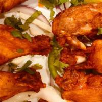 Buffalo Wings · Chicken wings marinated in  herbs and spices.