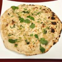 Garlic Naan · Traditional leavened white flour bread freshly cooked in a tandoor oven topped with garlic &...