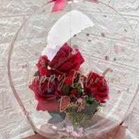Bouquet In Balloon · A small bouquet encased in a clear balloon.