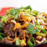 Irish Nachos · Homemade chili served over House fried potato chips topped with Guinness  cheese and Jalapeñ...