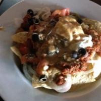 Loaded Nachos · Homemade Chili served over Nacho chips topped with cheddar cheese and Jalapeños with a dollo...