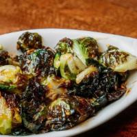 Brussel Sprouts · Lightly charred brussel sprouts tossed in a light bourbon style sauce