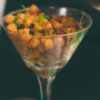 Roasted Chickpea Couscous Meal · Vegan. Roasted chickpeas, sautéed greens, spiced couscous, bell pepper, red onion, tomato, c...