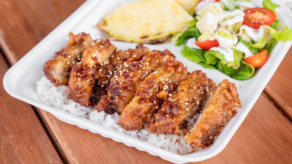 Mochiko Chicken · Gluten-Free. Chicken thigh marinated in Mochiko flour, soy sauce, sugar, ginger, garlic, onion. Deep-fried, served over rice, garnish with teriyaki sauce and sesame seeds, with side salad, and 2 pineapple wedges.