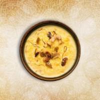 Aromatic Rice Pudding · Simple rice cooked in sweetened milk with add-ins like ground cinnamon and raisins