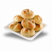 Garlic Knots · Strips of pizza dough knotted, baked, and tossed in garlic butter.