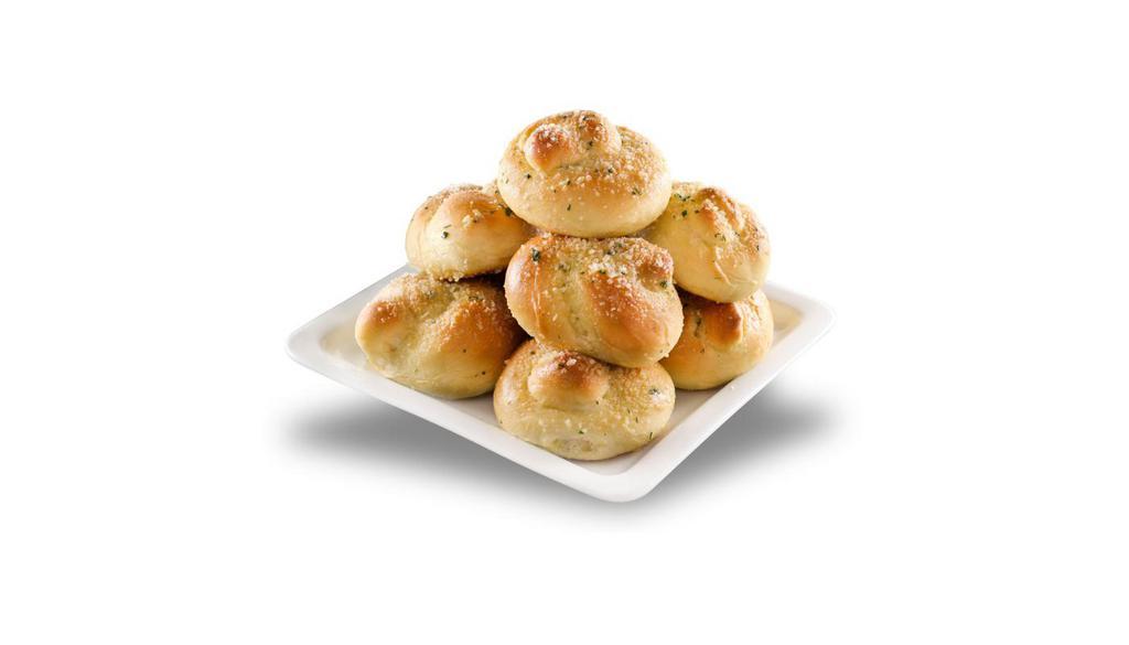 Garlic Knots · Strips of pizza dough knotted, baked, and tossed in garlic butter.