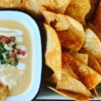 Queso Blanco & Sweetcorn Chips · Chihuahua cheese, roasted tomatoes, bell pepper, topped with pico de gallo.