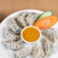 Chicken Momo (10) · Ground chicken marinated with fresh garlic and spices wrapped in flour dough and steamed. Se...