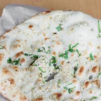 Garlic Naan · Traditional leavened white flour bread freshly cooked in a tandoor oven topped with garlic a...