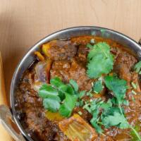 Lamb Curry · Bone-in lamb chunks cooked on slow heat with mild ginger, garlic, onion, spices & tomato bas...