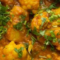 Aloo Gobi · Delicately hand-pulled fresh cauliflower & potatoes simmered in herbs & spices.