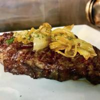 Rib Eye Steak · 12 oz Rib Eye (USDA Choice - Hand Cut), boneless, tender, grilled to perfection, topped with...