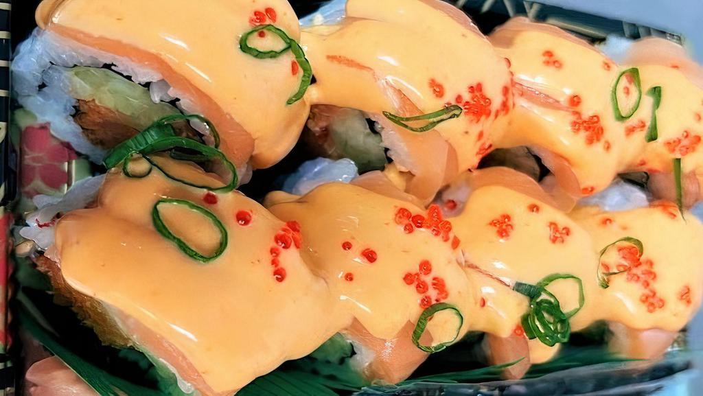 15 Dancing Salmon (8) · Gluten-free. Spicy salmon and cucumber inside topped with salmon, fish roe, green onion & spicy sauce. Served with ginger and wasabi.