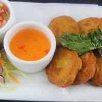 Tod Mun Pla · Thai fish cake with red curry, cilantro, coriander, egg and lime juice. Served with a sweet ...