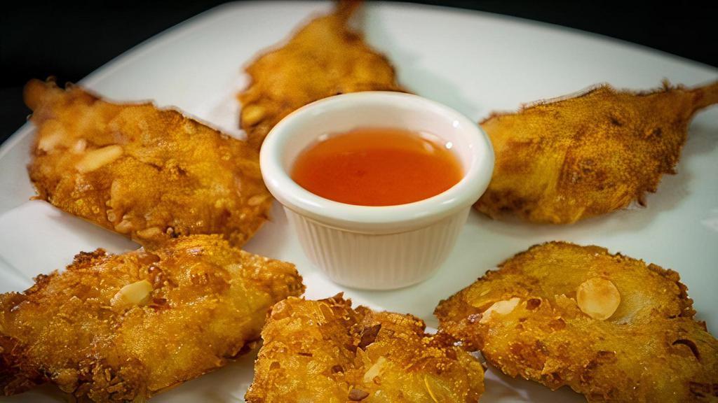 Coconut Prawns · Six golden prawns deep fried in coconut tempura batter and served with our sweet and sour sauce.