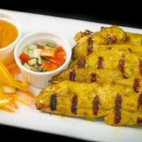 Chicken Satay · Marinated in a mixture of herbs and grilled. Served with peanut sauce and cucumber salad.