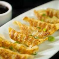 Gyoza Dumplings · Pan fried gyoza with mixed vegetables and chicken. Served with dumpling sauce.