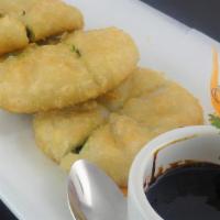 Gui Chai Dumplings · Pan fried chive dumpling served with sweet soy sauce vinaigrette.